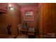 This room has wood paneled walls, a pink-painted window frame, and unique decor at 5958 Hoover Elmore Rd, Lincolnton, NC 28092