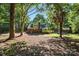 Large backyard surrounded by mature trees, providing ample privacy and shade at 6127 Eagle Peak Dr, Charlotte, NC 28214