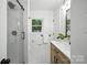 Bright bathroom with modern vanity, glass shower, and window view at 6127 Eagle Peak Dr, Charlotte, NC 28214