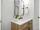 Modern bathroom vanity with wood grain cabinets, quartz countertop and black fixtures at 6127 Eagle Peak Dr, Charlotte, NC 28214