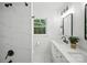 Bright bathroom featuring a marble tile shower and a modern vanity with matte black hardware at 6127 Eagle Peak Dr, Charlotte, NC 28214