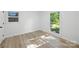 Sunlit bedroom with wood-look floors and large windows offering outdoor views at 6127 Eagle Peak Dr, Charlotte, NC 28214