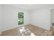 Minimalist bedroom with wood floors and window with green, leafy view at 6127 Eagle Peak Dr, Charlotte, NC 28214
