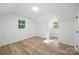 Bright bedroom with wood-look floors, natural light, and neutral decor at 6127 Eagle Peak Dr, Charlotte, NC 28214