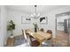 Light and airy dining room boasts modern lighting, stylish decor, and comfortable seating at 6127 Eagle Peak Dr, Charlotte, NC 28214