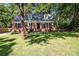 Charming brick home with dormer windows and a well-maintained front yard surrounded by mature trees at 6127 Eagle Peak Dr, Charlotte, NC 28214
