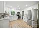 Open kitchen with stainless steel appliances, granite counters, white cabinets, and ample natural light at 6127 Eagle Peak Dr, Charlotte, NC 28214