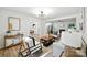 Bright living room with hardwood floors and modern decor, open to the kitchen and dining room at 6127 Eagle Peak Dr, Charlotte, NC 28214