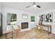 Sunlit living room featuring a white brick fireplace and hardwood floors and modern decor at 6127 Eagle Peak Dr, Charlotte, NC 28214