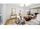 Bright living room with hardwood floors and modern decor, open to the kitchen and dining room at 6127 Eagle Peak Dr, Charlotte, NC 28214