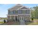 Beautiful two-story home showcasing stone accents, gray siding, and a well-manicured front yard at 660 14Th Avenue Ne Ct, Hickory, NC 28601