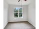 Simple bedroom with plush carpeting and a large window offering ample natural light at 7130 Founders Club Ct, Charlotte, NC 28269