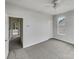 Neutral bedroom with plush carpet, ceiling fan and natural light from the large window at 7130 Founders Club Ct, Charlotte, NC 28269