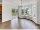 Bright dining area featuring a modern chandelier, large windows, and access to the backyard at 7130 Founders Club Ct, Charlotte, NC 28269