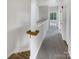 Upstairs hallway with plush carpet and natural light coming through the window at 7130 Founders Club Ct, Charlotte, NC 28269