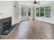 Bright living room featuring a fireplace and large windows offering ample natural light at 7130 Founders Club Ct, Charlotte, NC 28269