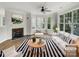 Bright, staged living room with fireplace, large windows, and stylish black and white accents at 7130 Founders Club Ct, Charlotte, NC 28269
