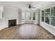Bright living room featuring a fireplace and large windows offering ample natural light at 7130 Founders Club Ct, Charlotte, NC 28269