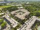 Wide aerial view of an apartment complex showing surrounding neighborhood, trees, and other buildings at 720 Governor Morrison St # 219, Charlotte, NC 28211
