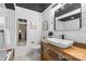 Modern bathroom featuring a rustic wood vanity, vessel sink, and black accents at 720 Governor Morrison St # 219, Charlotte, NC 28211