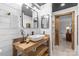 Bright bathroom featuring a rustic wood vanity, vessel sink, and dual mirrors at 720 Governor Morrison St # 219, Charlotte, NC 28211