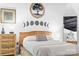 Close up of cozy bedroom with rustic wooden bed frame and eclectic decor at 720 Governor Morrison St # 219, Charlotte, NC 28211