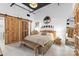 Cozy bedroom featuring rustic wooden bed frame, modern decor and sliding barn door at 720 Governor Morrison St # 219, Charlotte, NC 28211