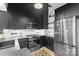 Stylish kitchen showcasing stainless steel appliances, dark cabinetry, and unique flooring design at 720 Governor Morrison St # 219, Charlotte, NC 28211
