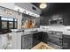 Contemporary kitchen featuring stainless steel appliances, dark cabinets, and a stylish tile backsplash and decorative flooring at 720 Governor Morrison St # 219, Charlotte, NC 28211