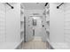 Bright laundry room with custom shelving, modern appliances and laundry sign at 720 Governor Morrison St # 219, Charlotte, NC 28211