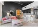 Modern living room featuring a plush pink sofa, open kitchen, and stylish decor at 720 Governor Morrison St # 219, Charlotte, NC 28211