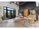 Open living room featuring a comfortable sofa, balcony access, and designer furnishings at 720 Governor Morrison St # 219, Charlotte, NC 28211