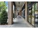 Exterior walkway with brick columns and shop fronts at 720 Governor Morrison St # 219, Charlotte, NC 28211