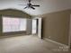 Bedroom with natural light from large windows and neutral-colored carpet at 9177 Bonnie Briar Cir, Charlotte, NC 28277