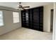 Bedroom featuring large built-in shelving, natural light, and neutral carpet at 9177 Bonnie Briar Cir, Charlotte, NC 28277