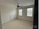 Bedroom with carpeting, ceiling fan, and a small storage space at 9177 Bonnie Briar Cir, Charlotte, NC 28277