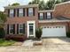 Charming two-story brick home with a well-manicured lawn, attached garage, and lovely curb appeal at 9177 Bonnie Briar Cir, Charlotte, NC 28277