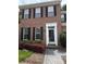 A close-up of the brick home's front entrance, showcasing a white trimmed doorway and decorative shrubs at 9177 Bonnie Briar Cir, Charlotte, NC 28277