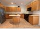 Well-equipped kitchen with wooden cabinets, tile floors, and modern appliances at 9177 Bonnie Briar Cir, Charlotte, NC 28277