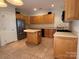 Spacious kitchen with an island, stainless steel appliances, and ample cabinet space at 9177 Bonnie Briar Cir, Charlotte, NC 28277