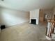 Spacious living room featuring a fireplace and staircase, perfect for Gathering gatherings at 9177 Bonnie Briar Cir, Charlotte, NC 28277