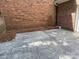 Stamped concrete patio with brick wall and sparse landscaping provides low-maintenance outdoor living at 9177 Bonnie Briar Cir, Charlotte, NC 28277