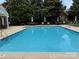 Community pool area with ample seating and lush landscaping, perfect for relaxing and enjoying the outdoors at 9177 Bonnie Briar Cir, Charlotte, NC 28277