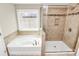 Bright bathroom featuring a separate tub and glass-enclosed shower with neutral-toned tile at 10004 Perth Moor Rd, Charlotte, NC 28278