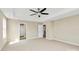 Spacious bedroom with a ceiling fan, neutral paint, and carpet; door to bathroom at 10004 Perth Moor Rd, Charlotte, NC 28278
