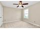 Neutral bedroom featuring a ceiling fan, closet, and carpet flooring at 10004 Perth Moor Rd, Charlotte, NC 28278