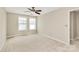Bright bedroom featuring two windows, neutral paint and plush carpeting at 10004 Perth Moor Rd, Charlotte, NC 28278