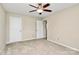 Spacious bedroom featuring neutral paint, a ceiling fan, and plush carpeting at 10004 Perth Moor Rd, Charlotte, NC 28278