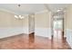 Bright dining room featuring hardwood floors, wainscoting and elegant chandelier at 10004 Perth Moor Rd, Charlotte, NC 28278