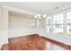 Bright dining room featuring hardwood floors, wainscoting and plenty of natural light at 10004 Perth Moor Rd, Charlotte, NC 28278